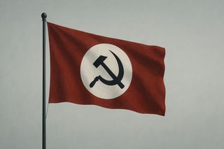 A red flag on a flag pole with a white circle in it. Inside the white circle, a black hammer and sickle emblem